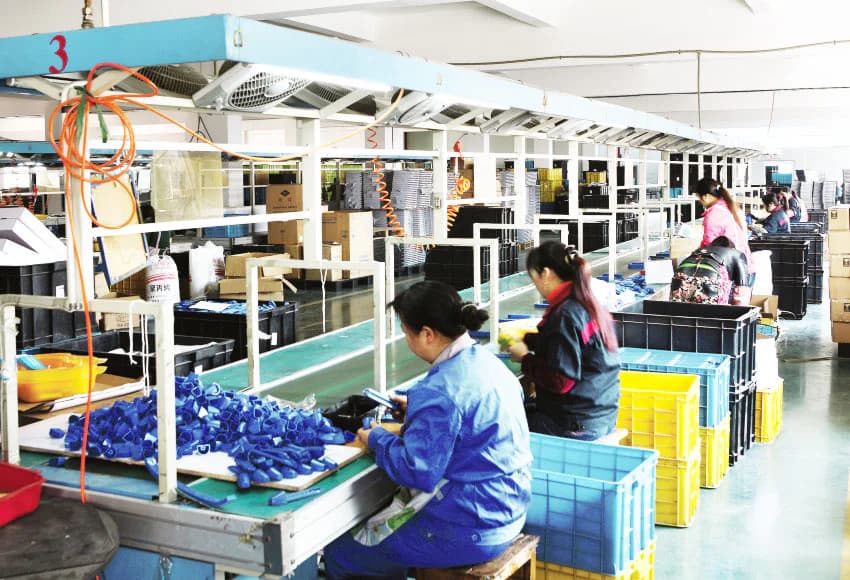 A Longteng team member works on outdoor play components during assembly and fit checking.